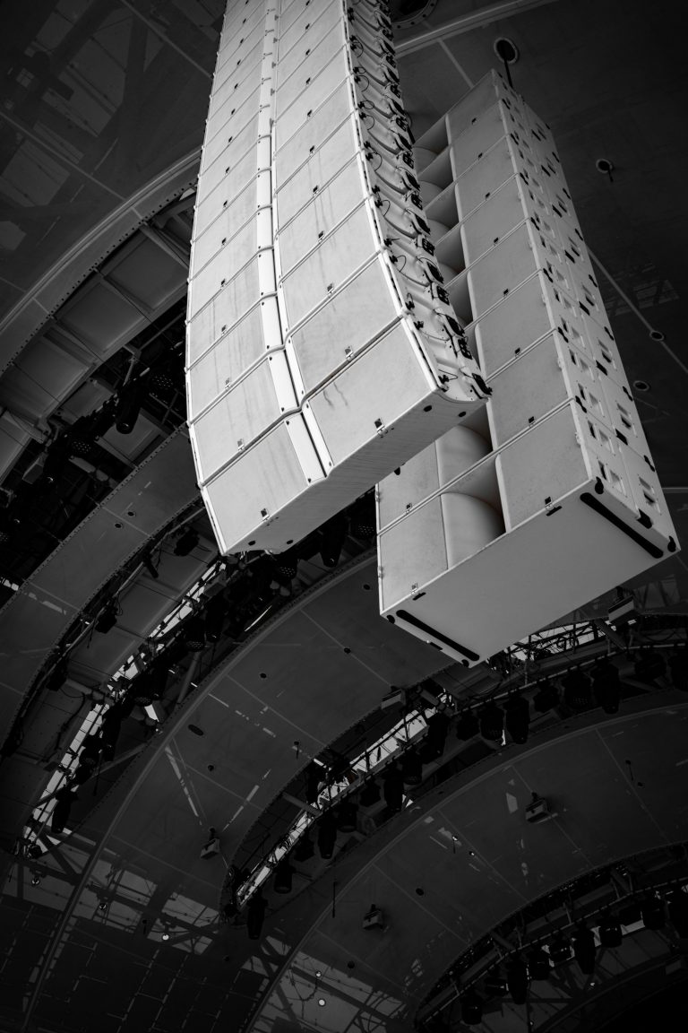 Speaker arrays suspended for ambient audio distribution (temporary stock photo)