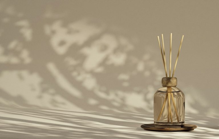 Reed diffuser casting shadows, a fragrance diffusion device (temporary stock photo)